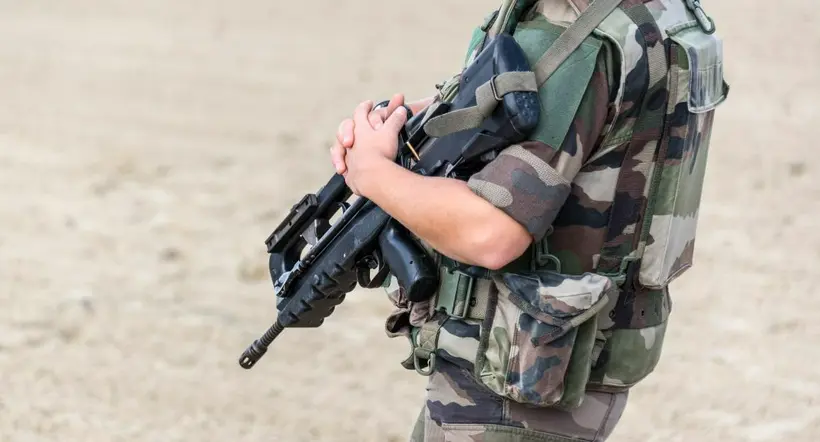 Close up of a French soldier with an automatic riffle, war and emergency state concept