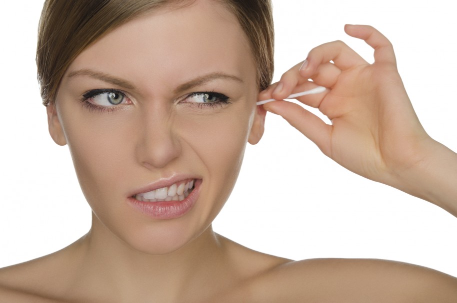 woman injured cleans ears with cotton sticks isolated on white