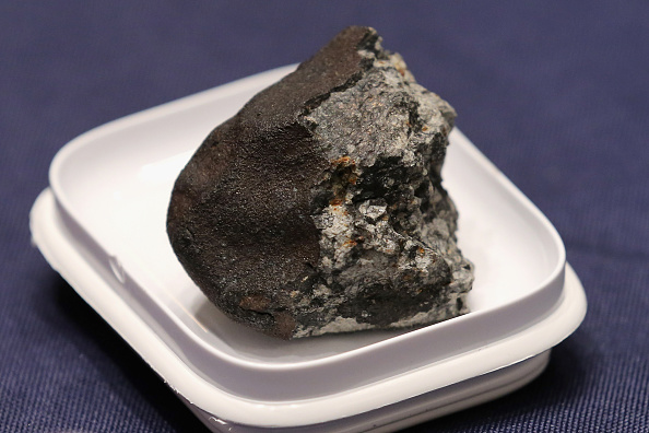 WASHINGTON, DC - JUNE 17:  A piece of the Chelyabinsk meteorite is displayed before a hearing of the House Administration Committee in the Longworth House Office Building on Capitol Hill June 17, 2015 in Washington, DC. Famously caught by a number of video cameras, the meteorite fell to earth February 15, 2013 and caused a large amount of damage in the city of Chelyabinsk, Russia.  (Photo by Chip Somodevilla/Getty Images)