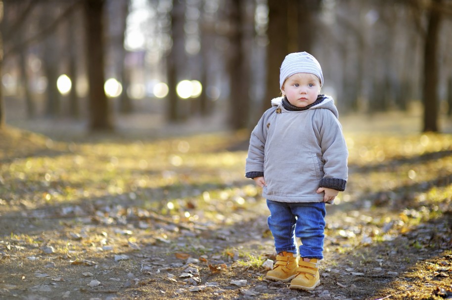 Beautiful toddler boy walking outdoors