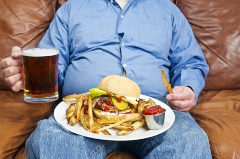 Hombre con sobrepeso y comiendo