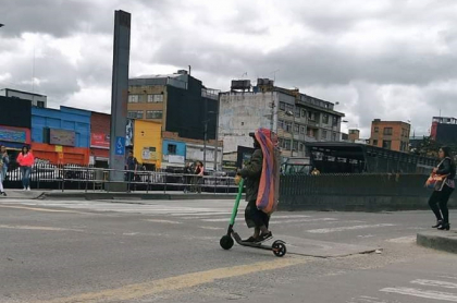 Habitante de calle conduciendo patineta eléctrica.