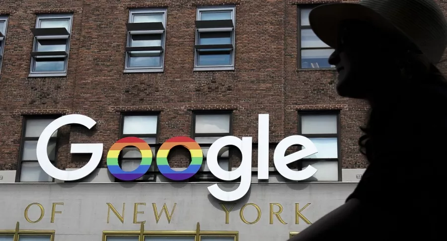 Mujer pasa frente a logo de Google
