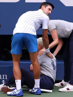 NEW YORK, NEW YORK - SEPTEMBER 06: Novak Djokovic of Serbia tends to a lineswoman after inadvertently striking her with a ball hit in frustration during his Men's Singles fourth round match against Pablo Carreno Busta of Spain on Day Seven of the 2020 US Open at the USTA Billie Jean King National Tennis Center on September 6, 2020 in the Queens borough of New York City. Al Bello/Getty Images/AFP