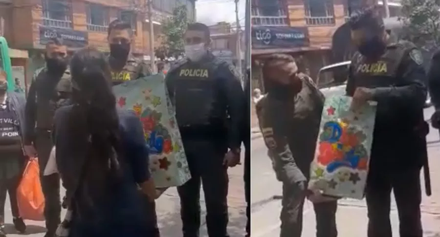 Captura del video de unos vecinos entregando regalo a policías en Bogotá después de disturbios recientes.