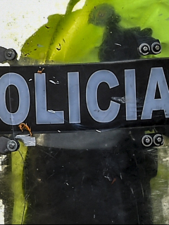 (FILES) In this file picture taken on September 9, 2020 riot police stand guard during a protest against the death of a lawyer under police custody, in Bogota. - Colombian prosecutors on September 18, 2020 charged two police officers with torture and aggravated homicide after the death of a man in custody sparked deadly rioting in the capital and other cities. The two police involved in the arrest of Javier Ordonez, who was repeatedly tasered before dying later in custody, were charged with "torture and aggravated homicide," prosecutor's office official Francisco Barbosa said. Five other police officers are under investigation in the case. (Photo by Juan BARRETO / AFP)