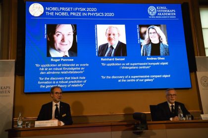 David Haviland (L), member of the Nobel Committee for Physics, and Goran K Hansson, Secretary General of the Academy of Sciences, sit in front of a screen displaying the winners of the 2020 Nobel Prize in Physics (L-R) Briton Roger Penrose, Reinhard Genzel of Germany  and Andrea Ghez of the US, during a press conference at the Royal Swedish Academy of Sciences, in Stockholm, on October 6, 2020. - Roger Penrose of Britain, Reinhard Genzel of Germany and Andrea Ghez of the US won the Nobel Physics Prize on Tuesday for their research into black holes, the Nobel jury said. (Photo by Fredrik SANDBERG / TT NEWS AGENCY / AFP) / Sweden OUT