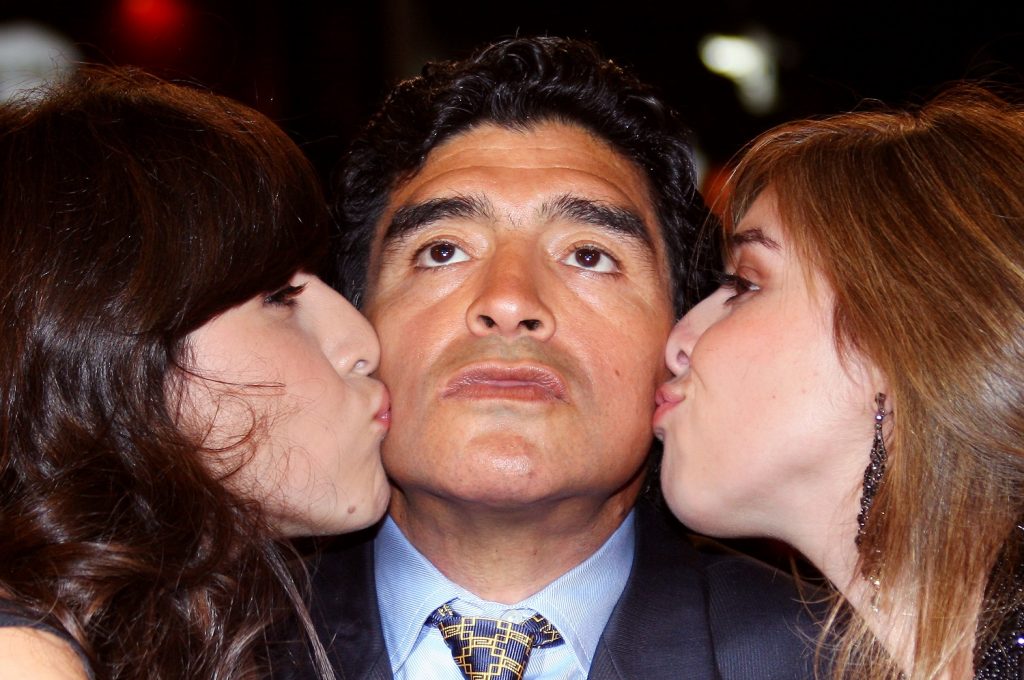 Diego Maradona and two of his daughters / AFP