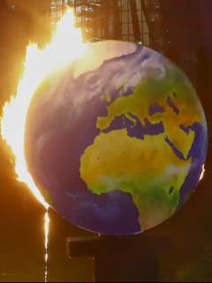Un mundo en llamas, para alertar sobre el calentamiento global, es usado por activistas del grupo ambientalista Koala Kollektiv, durante una protesta frente a la sede del Banco Central Europeo (BCE) en Frankfurt am Main, Alemania, el 21 de octubre de 2020.