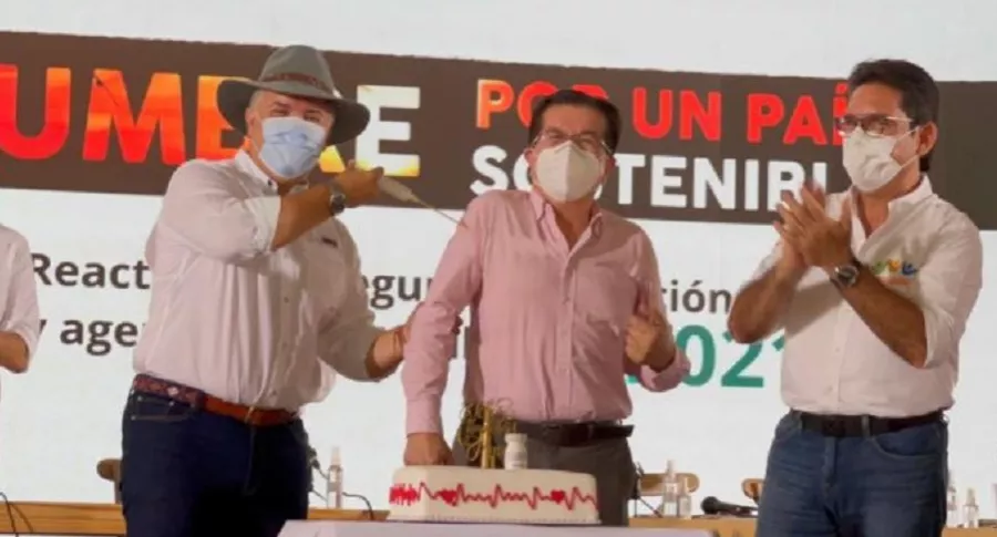 Iván Duque celebrando el cumpleaños del ministro de Salud y vacunándolo con jeringa de pastillaje