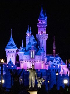 Vista general de la estatua de Walt Disney y Mickey Mouse frente al Castillo de la Bella Durmiente en el Parque Disneyland, que reabrirá en abril junto a otros parques temáticos de California, Estados Unidos.