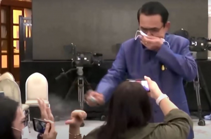 Captura de pantal del video del primer ministro tailandés Chan-ocha rocía desinfectante a periodistas