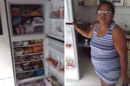 Mujer en Cali celebrando que su nevera quedó llena luego de robo a supermercado