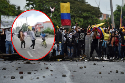 Imagen de mamá sacando a su hijo de protestas y de manifestantes en Colombia