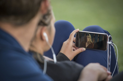 Foto de personas viendo un dispositivo móvil, en referencia a nota de qué hacer cuando publican fotos y videos íntimos.