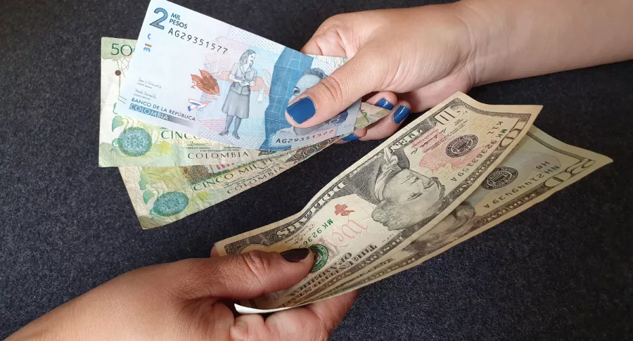 Foto de billetes de pesos colombianos y dólares, en nota de aumento del dólar en Colombia y razones que lo motivan.
