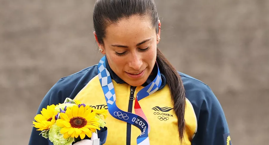 Mariana Pajón mirando su medalla en Tokio 2020, deportista que defendió a Simone Biles