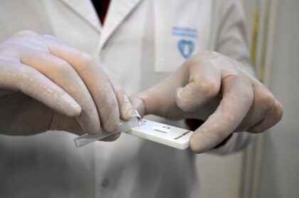 Médico haciendo test, mientras Brasil confirma primeros casos de variante Ómicron de coronavirus.