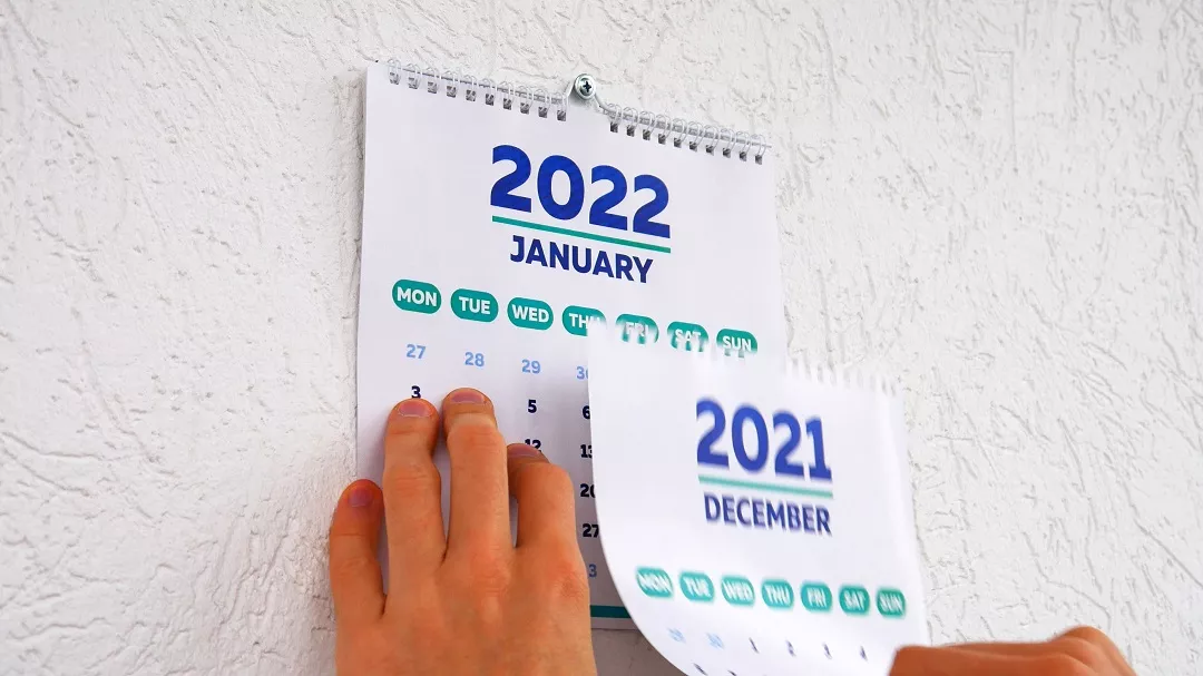 Persona cambiando calendario ilustra nota de los festivos que habrá en el 2022 en Colombia
