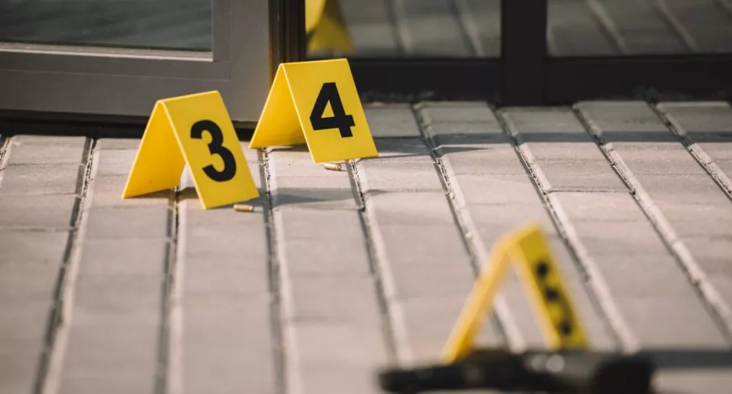blured close up view of crime scene with gun and numbers