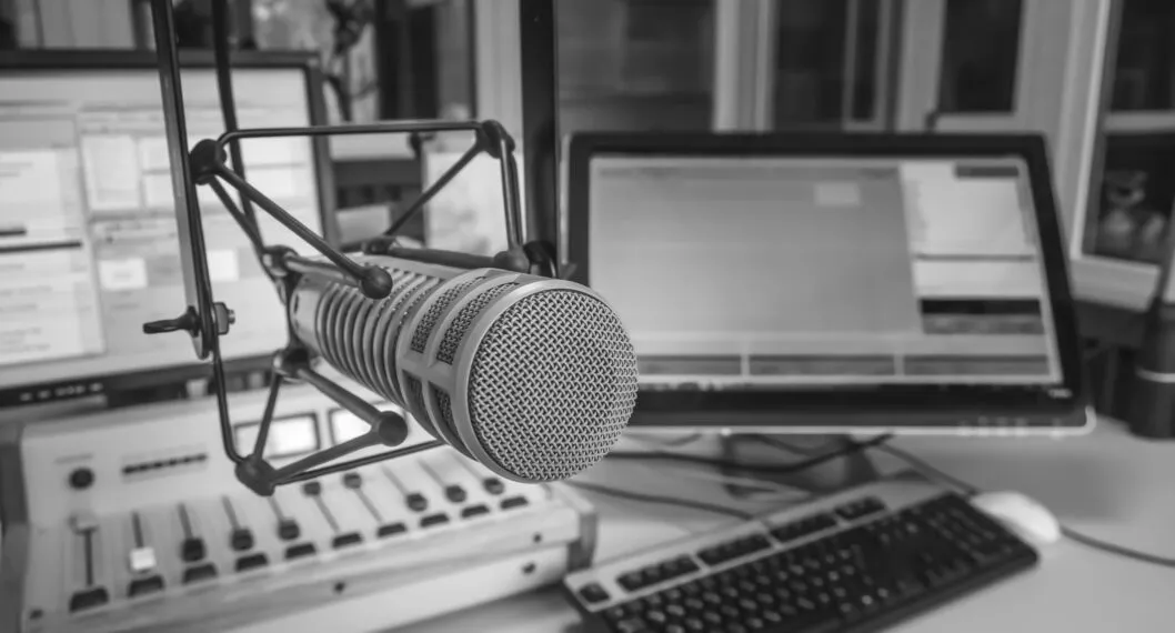 Radio station studio. Professional microphone, audio console and computer screens