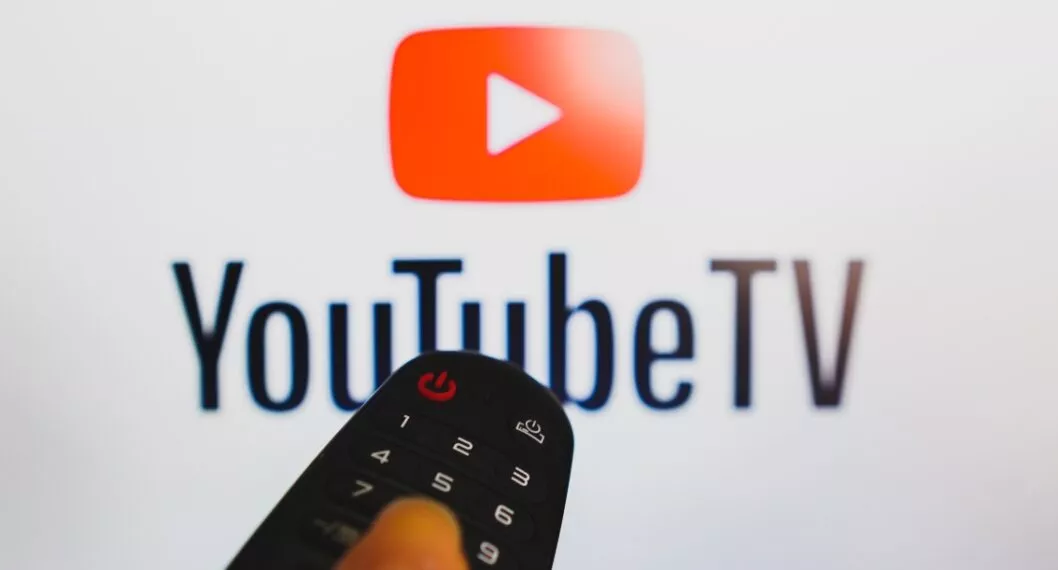 BRAZIL - 2022/05/10: In this photo illustration, a hand holding a TV remote control in front of a YouTube logo on a TV screen. (Photo Illustration by Rafael Henrique/SOPA Images/LightRocket via Getty Images)