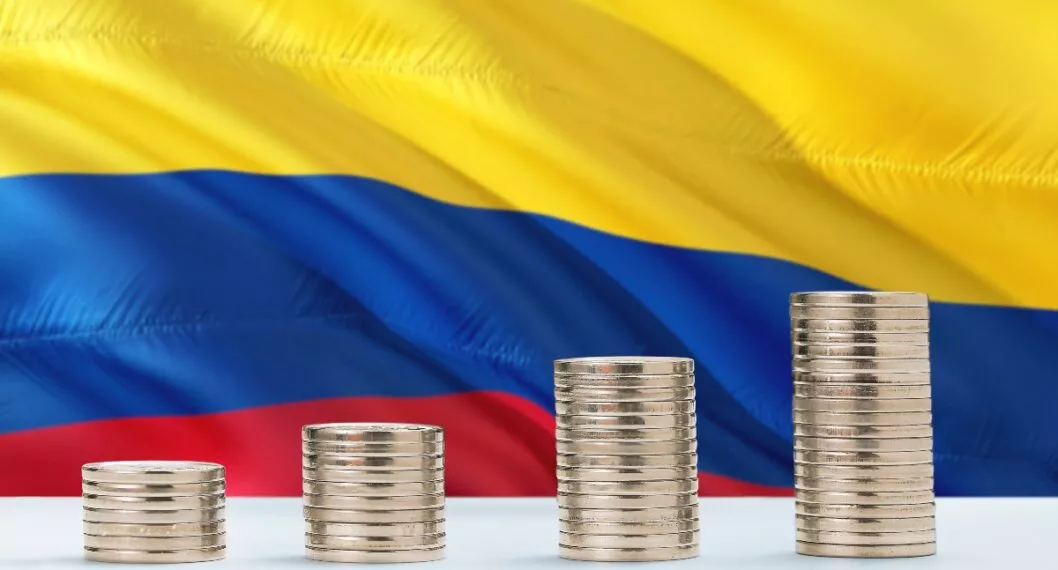 Colombia flag waving in the background with rows of coins for finance and business concept. Saving money.