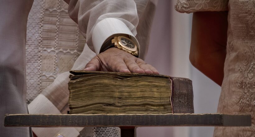 MANILA, PHILIPPINES - JUNE 30: Ferdinand "Bongbong" Marcos Jr. places his hand on a bible as he takes his oath as the next Philippine President, at the National Museum of Fine Arts on June 30, 2022 in Manila, Philippines. Ferdinand "Bongbong" Marcos Jr. took his oath as the next Philippine President on Thursday, completing a once unthinkable political revival of his family 36 years after his dictator father, Ferdinand Marcos Sr., was ousted by millions of Filipinos in a people power revolution. (Photo by Ezra Acayan/Getty Images)
