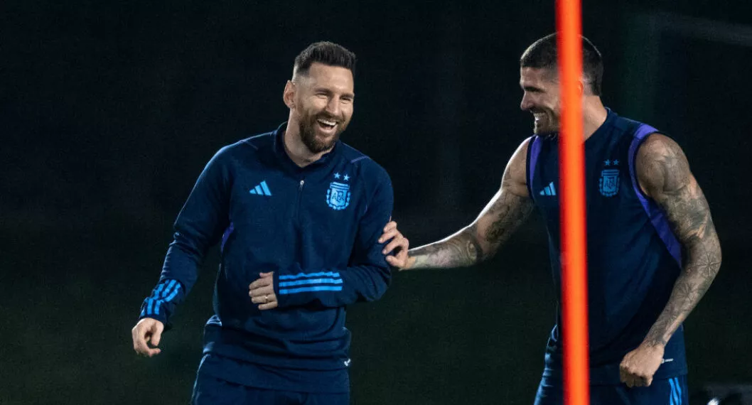 DOHA, QATAR - DECEMBER 12: Lionel Messi and Rodrigo De Paul of Argentina laughs during the Argentina Training Session on December 12, 2022 in Doha, Qatar. (Photo by Sebastian Frej/MB Media/Getty Images)