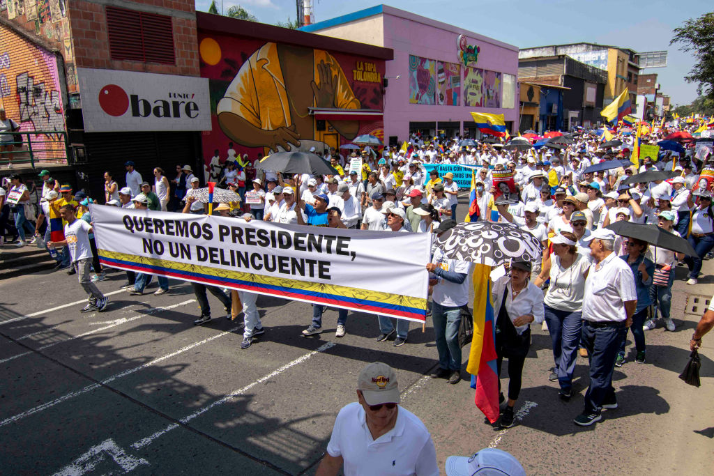 Demonstrators hold signs against Colombian president Gustavo Petro during the anti-government protests against the government and reforms of president Gustavo Petro, in Cali, Colombia, June 20, 2023. (Photo by: Sebastian Marmolejo/Long Visual Press/Universal Images Group via Getty Images)