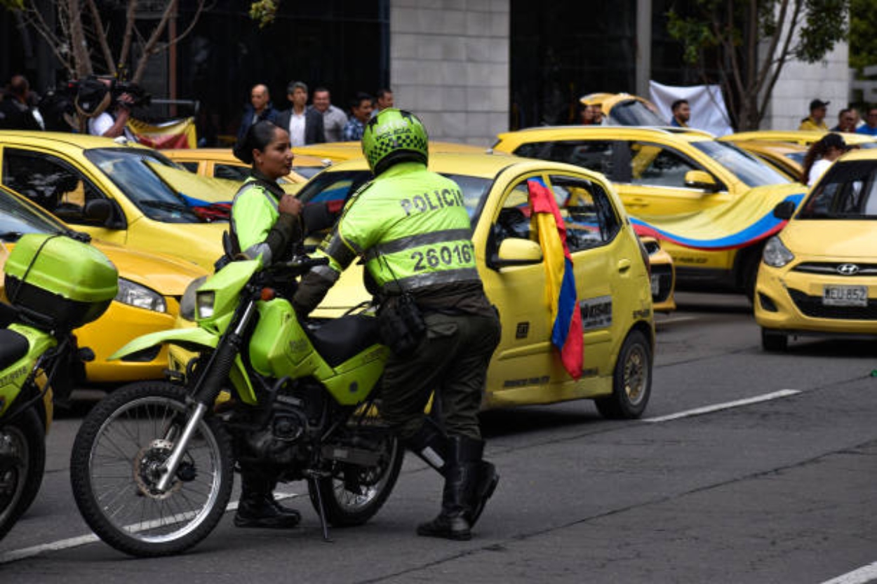 Colombian transit police officers are seen during demonstrations as taxi drivers block streets in Bogota, Colombia to demonstrate against the Colombian government decision to raise fuel prices, on August 9, 2023. (Photo by: Jessica Patino/Long Visual Press/Universal Images Group via Getty Images