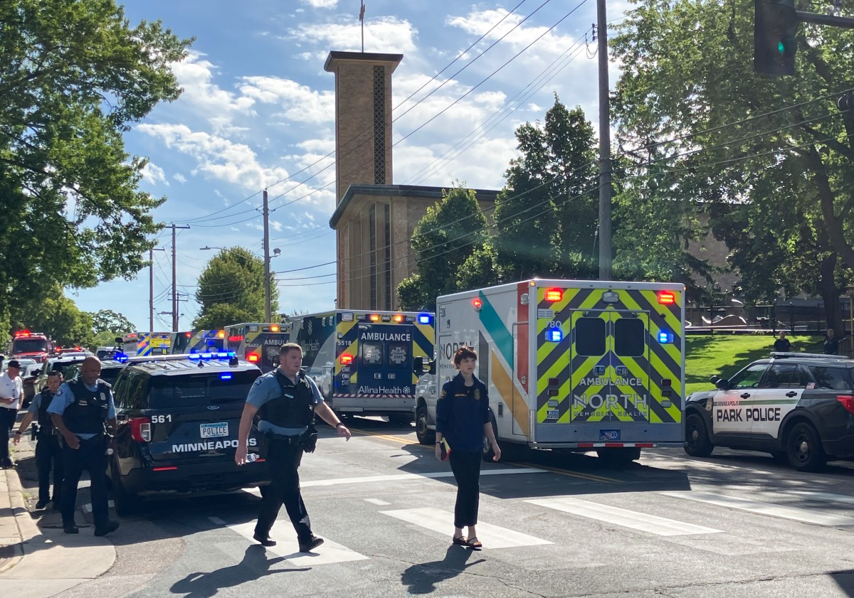 Police and first responders work at the scene of a shooting near Annunciation Church and Catholic School in Minneapolis, Minneosta, on August 27, 2025. Two children were shot dead when a gunman attacked a Minneapolis church on Wednesday, with 17 people injured, 14 of them children, police said. The gunman "began firing a rifle through the church windows towards the children sitting in the pews at the mass," Minneapolis police chief Brian O'Hara told reporters. The pupils were marking the first week of the school year when the attack occurred. (Photo by Tom BAKER / AFP)