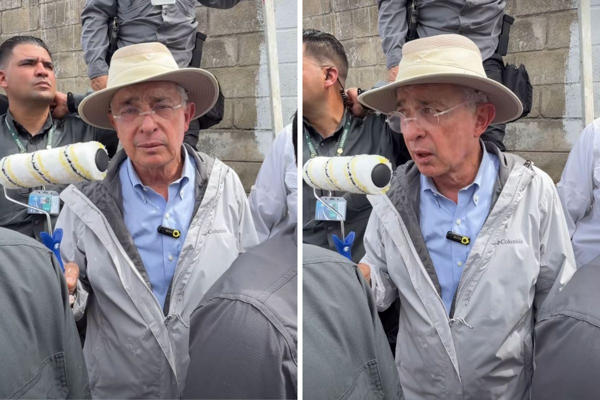 Momento en el que Álvaro Uribe saca un rodillo para pintar un mural sobre falsos positivos que hicieron cerca de su casa