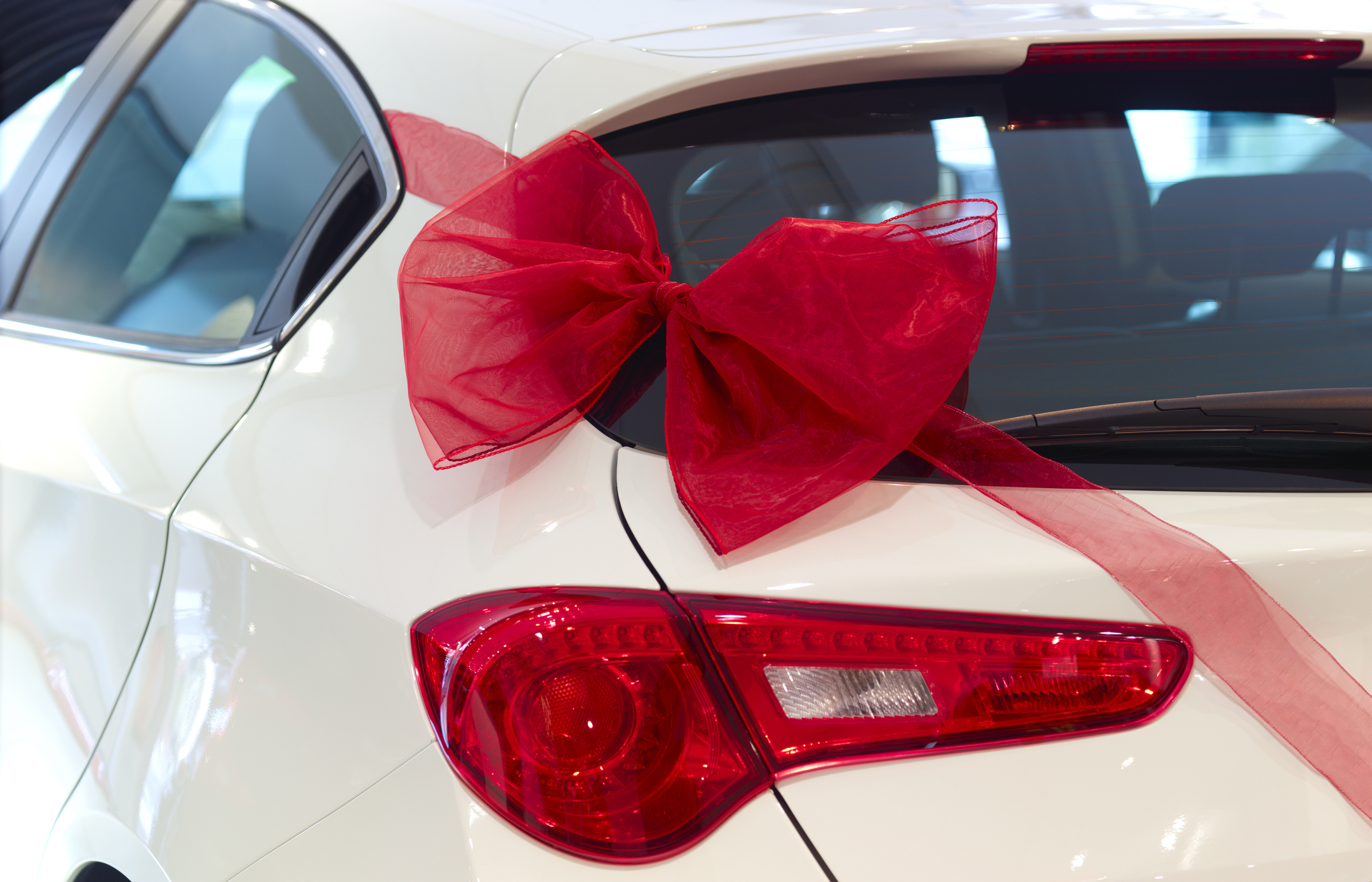New car with red ribbon and red bow