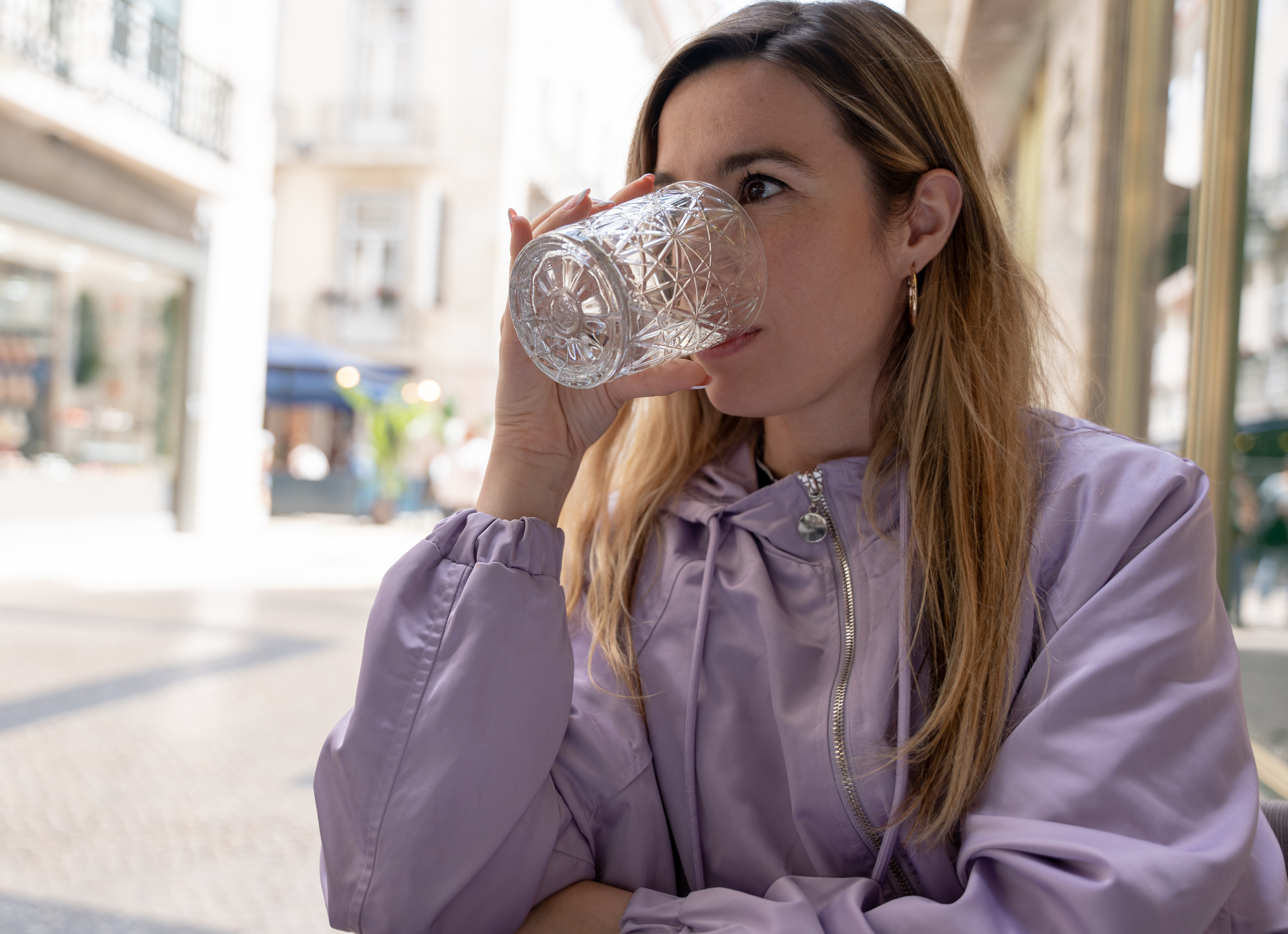 Sparkling or still water, soft drinks, mineral water or hydration options by drinking from a glass. Close view.