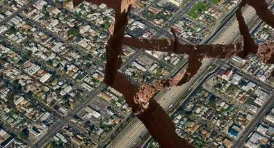 Vista aérea de una ciudad con grietas y hendiduras por un terremoto, a propósito de cómo diferenciar un temblor y un terremoto.
