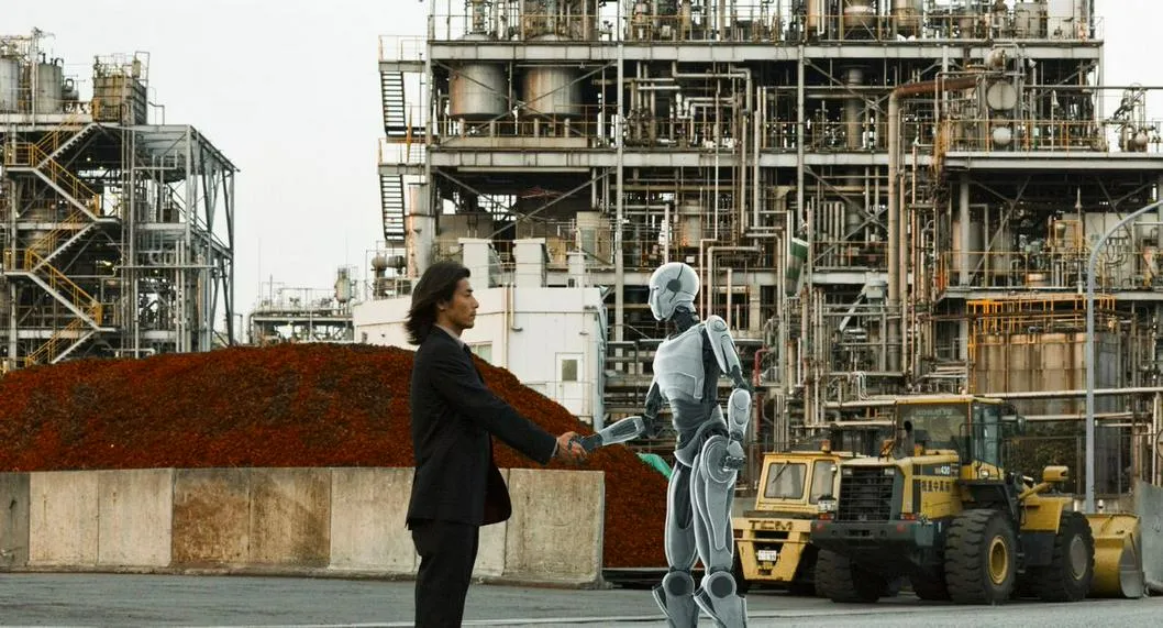 Trabajador junto a un robot a propósito de qué profesiones serán reemplazadas por la inteligencia artificial.