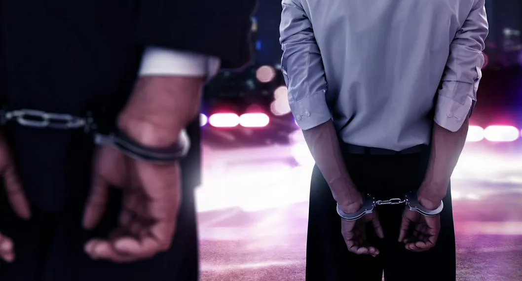 Two businessman in handcuffs