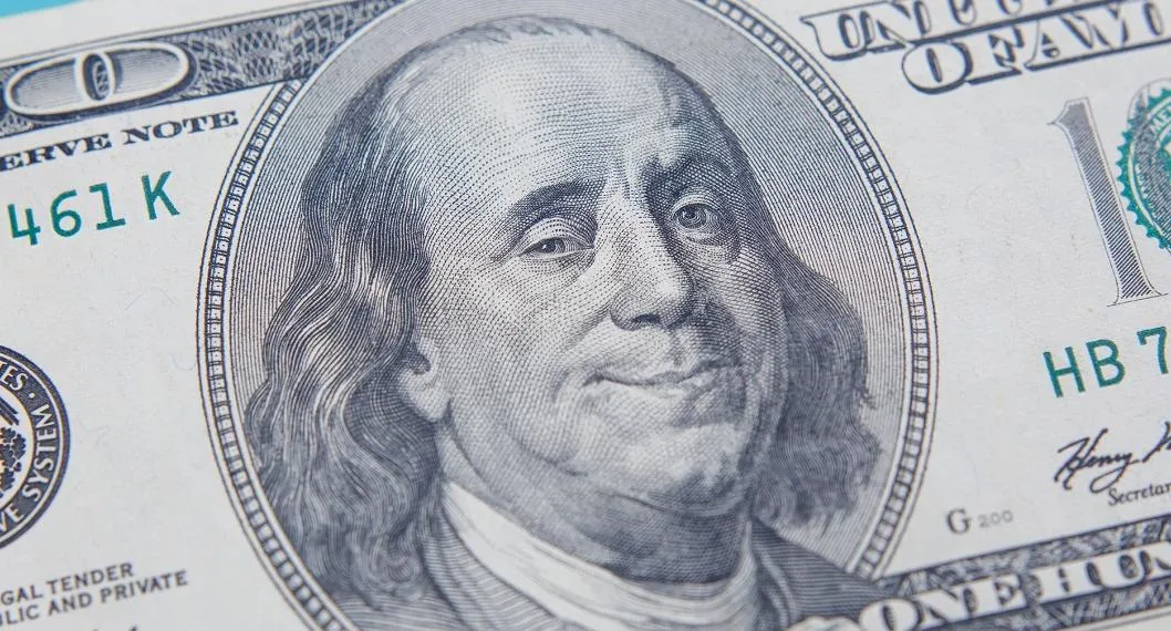 US hundred dollar bill with smiling and winking Benjamin Franklin