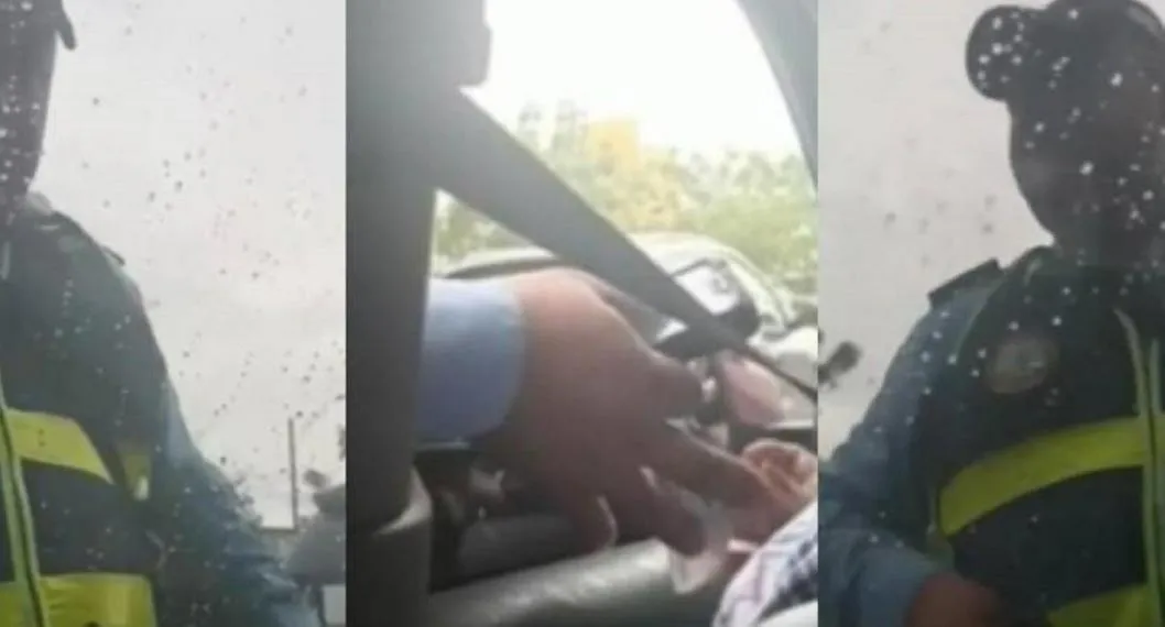 El agente de transito haciendo la ‘transacción’ con la conductora infractora, en Cartagena. 