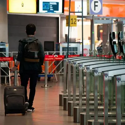 A man walks with his luggage during the launch of 'BIOMIG' a new biometric migration system aimed for foreigners in El Dorado International Airport, in Bogota, Colombia, June 2, 2023.