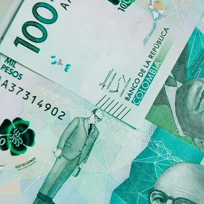 colombian money, one hundred thousand pesos on white background
