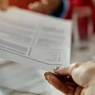 Mujer entregando una hoja de vida, estos son algunos tips para realizarla correctamente.