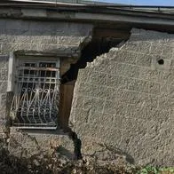 Damaged house dilapidated old building wall in Georgia. Private abandoned home fall to ruin. Sunny day, horizontal orientation, nobody.