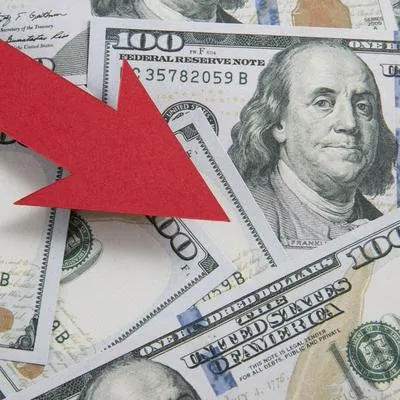 Inflation and rate falling concept with red arrow and one hundred American dollar bill