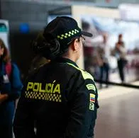 A Colombian police officer looks on during a play showing the risks and the ways in which people are tricked into illegal human trafficking networks, at El Dorado International Airport in Bogota, Colombia July 28, 2023. (Photo by: Sebastian Barros/Long Visual Press/Universal Images Group via Getty Images)