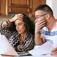 Young woman sitting at home and making home finances, with casual clothes.