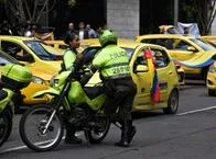 Colombian transit police officers are seen during demonstrations as taxi drivers block streets in Bogota, Colombia to demonstrate against the Colombian government decision to raise fuel prices, on August 9, 2023. (Photo by: Jessica Patino/Long Visual Press/Universal Images Group via Getty Images