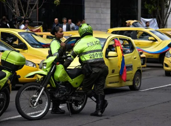 Colombian transit police officers are seen during demonstrations as taxi drivers block streets in Bogota, Colombia to demonstrate against the Colombian government decision to raise fuel prices, on August 9, 2023. (Photo by: Jessica Patino/Long Visual Press/Universal Images Group via Getty Images