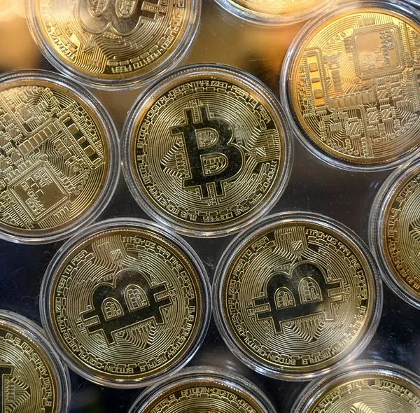 Physical imitation of Bitcoins are pictured at a cryptocurrency exchange branch near the Grand Bazaar in Istanbul on October 20, 2021, a day after Bitcoin took another step closer to mainstream investing with the launch of a new security on Wall Street tied to futures of the cryptocurrency. (Photo by Ozan KOSE / AFP)